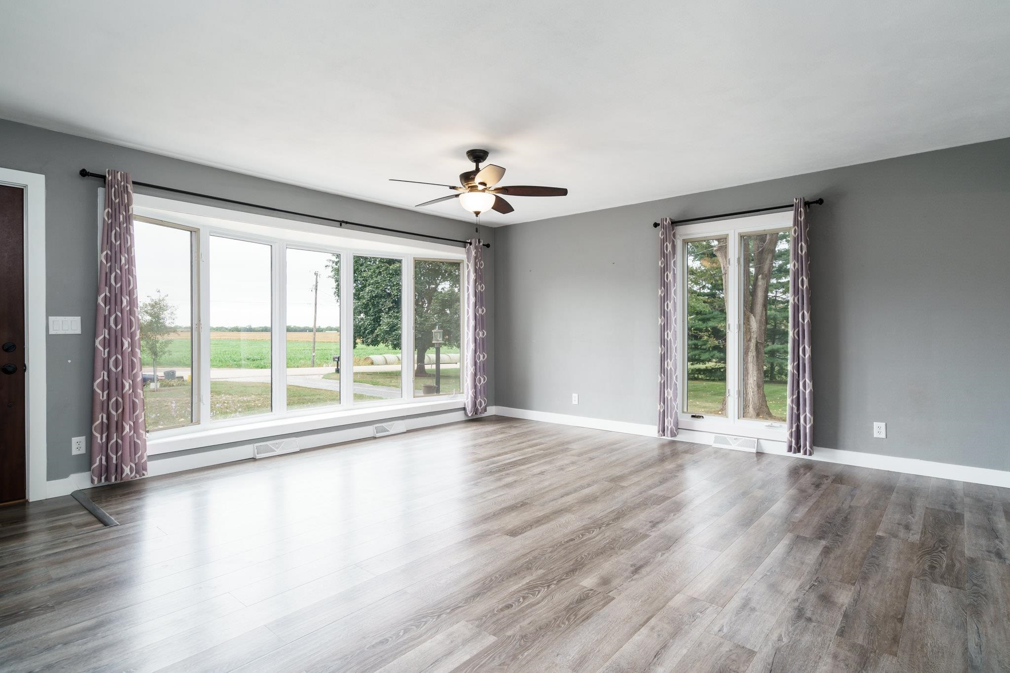 6780 Manchester Road South Beloit, IL 61080 - Photo 5 of 44 a view of an empty room with wooden floor and a window