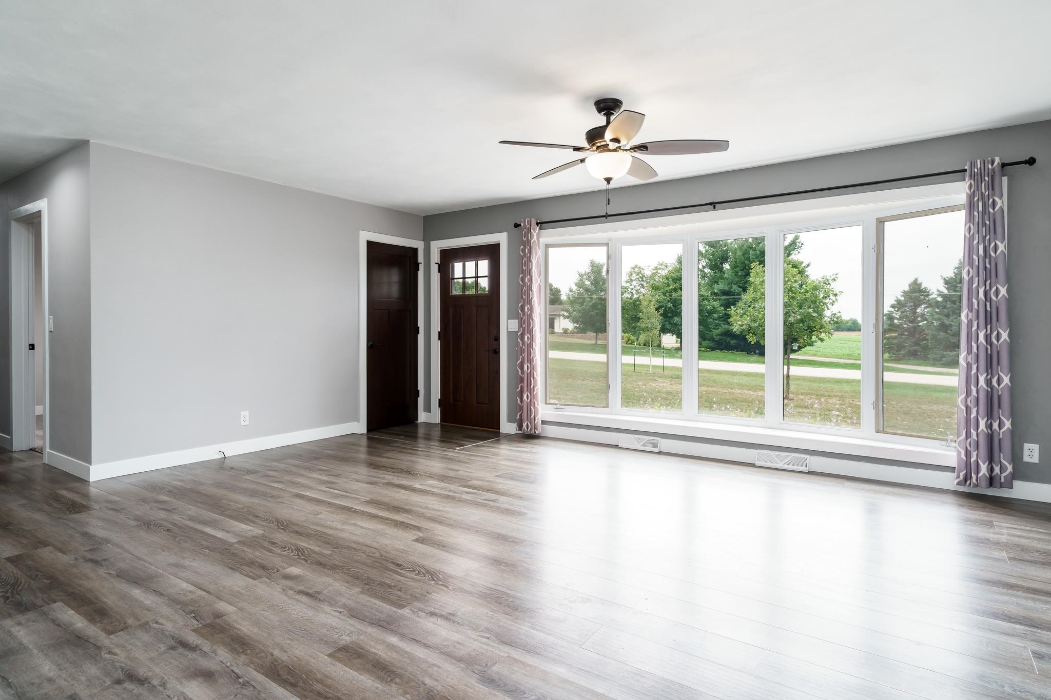 6780 Manchester Road South Beloit, IL 61080 - Photo 6 of 44 a view of an empty room with wooden floor and a window