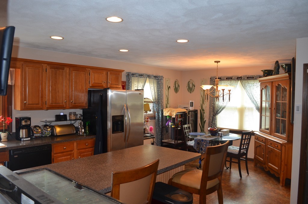 30 Raleigh Road Weymouth, MA 02189 - Photo 2 of 27 a kitchen with refrigerator and chairs