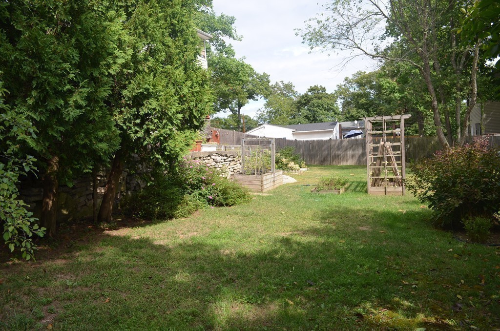 30 Raleigh Road Weymouth, MA 02189 - Photo 26 of 27 a backyard of a house with lots of green space and fountain