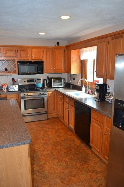 30 Raleigh Road Weymouth, MA 02189 - Photo 3 of 27 a large kitchen with stainless steel appliances granite countertop a stove a sink and a microwave