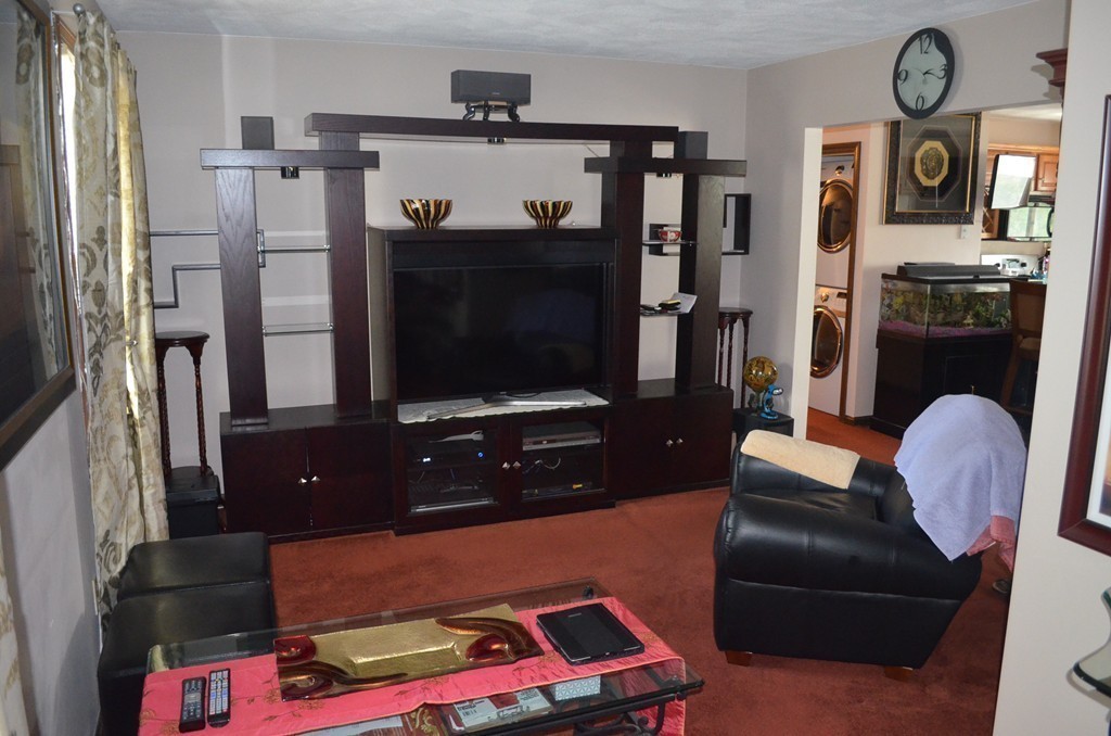 30 Raleigh Road Weymouth, MA 02189 - Photo 7 of 27 a living room with furniture and a flat screen tv