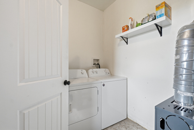 5264 West 5500th Street South Hooper, UT 84315 - Photo 12 of 38 Dedicated utility area featuring a white paneled door with black hardware, neutral wall paint, and a floating wall shelf
