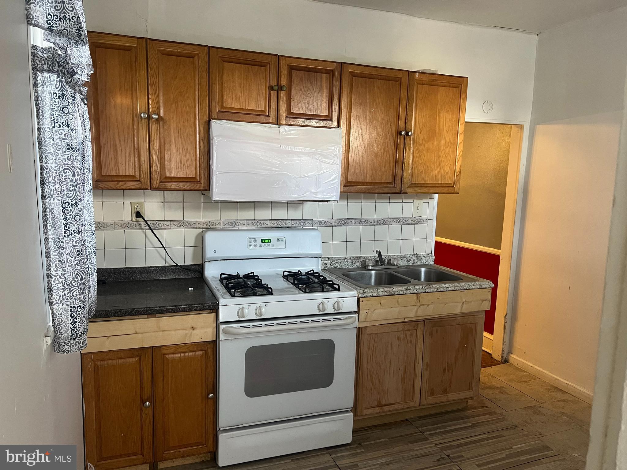6925 Forrest Avenue Philadelphia, PA 19138 - Photo 4 of 12 a kitchen with a stove top oven and cabinets
