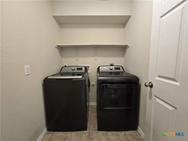 a view of storage and utility room with racks on the wall