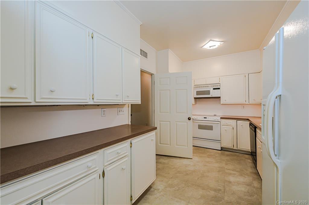 834 Cherokee Road Charlotte, NC 28207 - Photo 12 of 22 a kitchen with white cabinets and stainless steel appliances