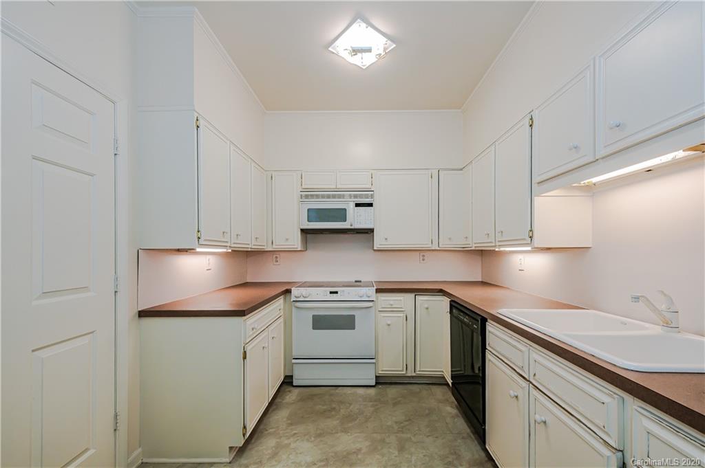 834 Cherokee Road Charlotte, NC 28207 - Photo 13 of 22 a kitchen with cabinets appliances a sink and a counter top space