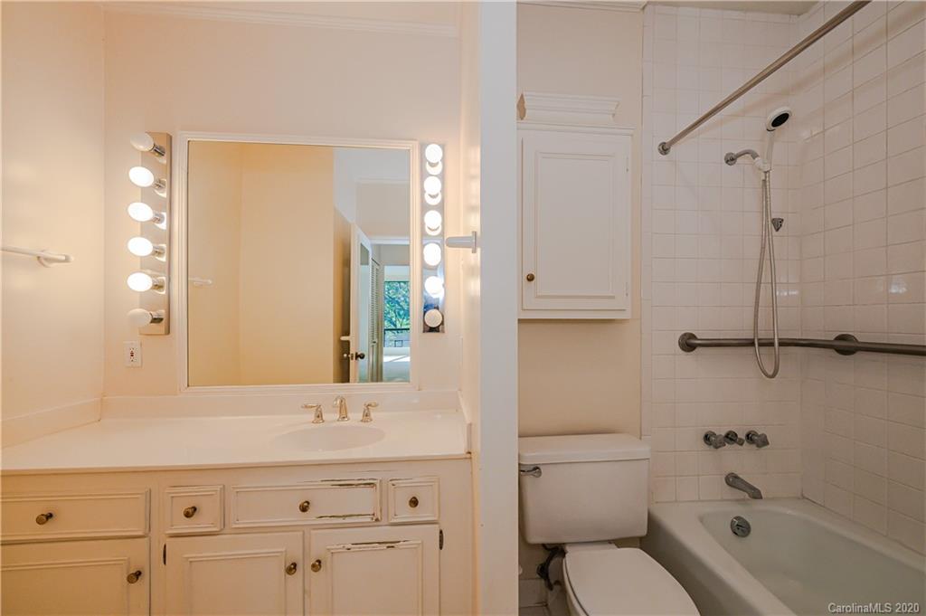 834 Cherokee Road Charlotte, NC 28207 - Photo 19 of 22 a bathroom with a granite countertop sink a toilet and shower