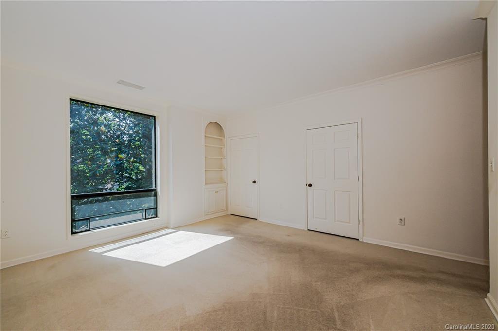 834 Cherokee Road Charlotte, NC 28207 - Photo 20 of 22 a view of an empty room with wooden floor and a window