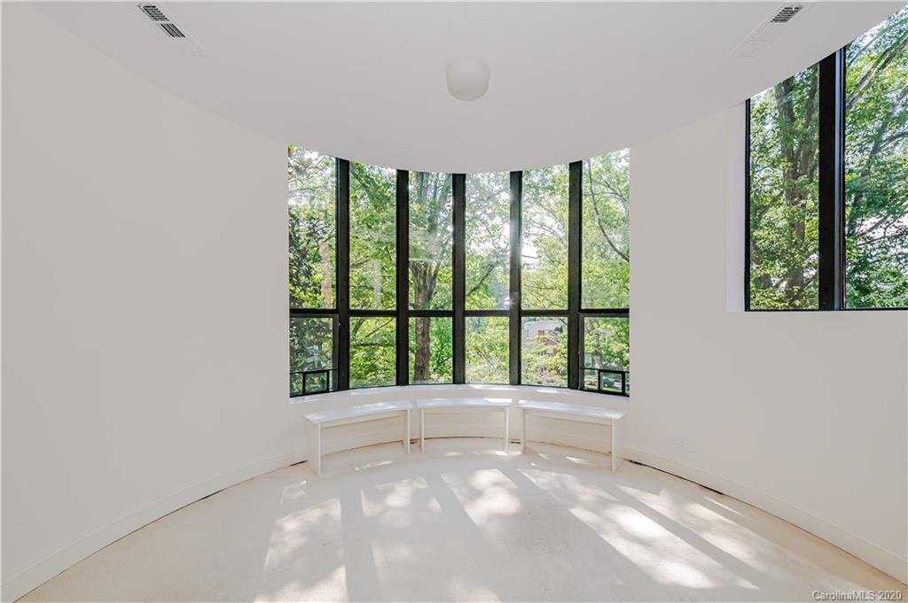 834 Cherokee Road Charlotte, NC 28207 - Photo 8 of 22 a view of an empty room with large windows