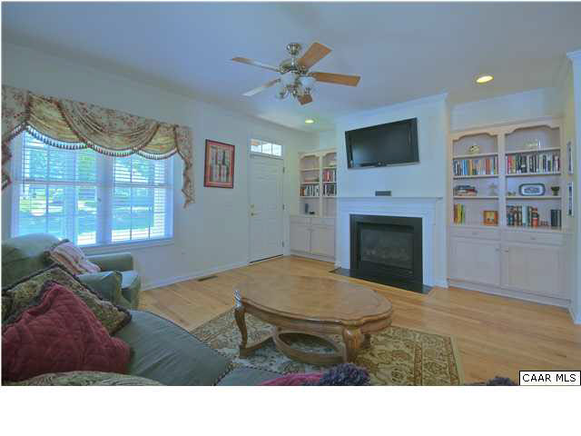 913 Raymond Road Charlottesville, VA 22902 - Photo 2 of 31 a living room with furniture a flat screen tv and a fireplace