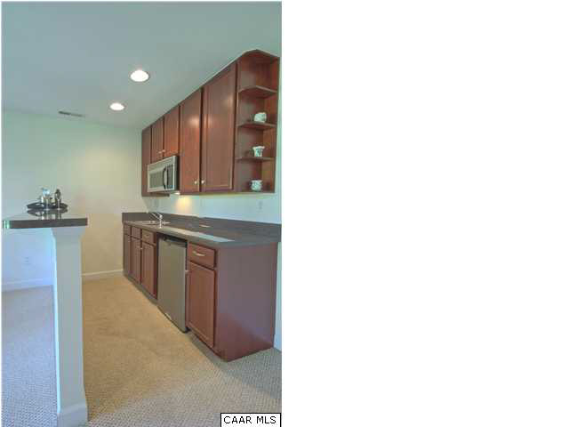 913 Raymond Road Charlottesville, VA 22902 - Photo 23 of 31 a kitchen with kitchen island cabinets and oven