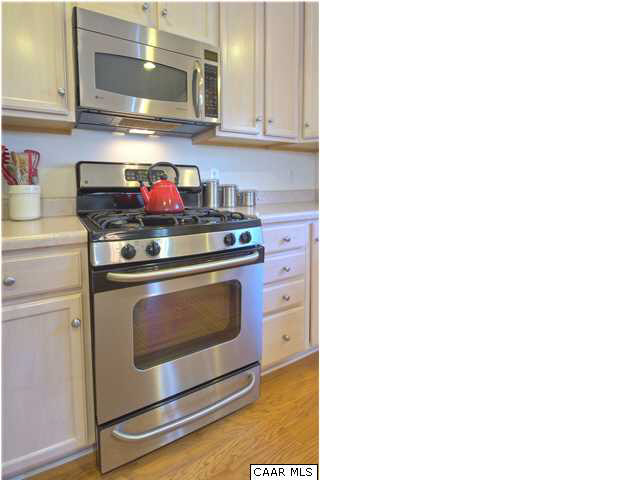 913 Raymond Road Charlottesville, VA 22902 - Photo 6 of 31 a kitchen with stainless steel appliances granite countertop a stove and a microwave