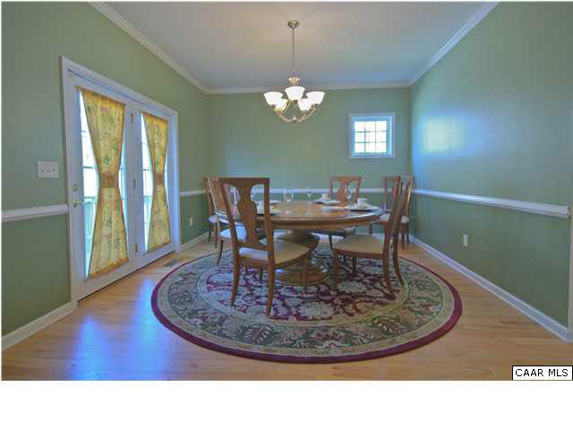 913 Raymond Road Charlottesville, VA 22902 - Photo 8 of 31 a view of a dining room with furniture wooden floor and a chandelier