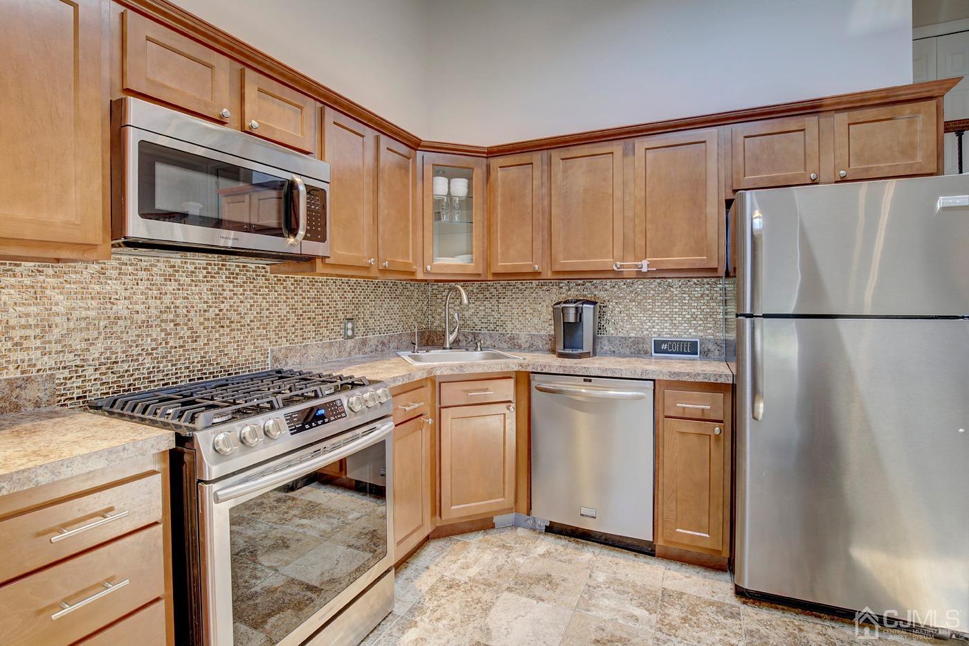 5 Thomas Street Old Bridge, NJ 08857 - Photo 11 of 36 a kitchen with stainless steel appliances granite countertop a stove a refrigerator and a microwave