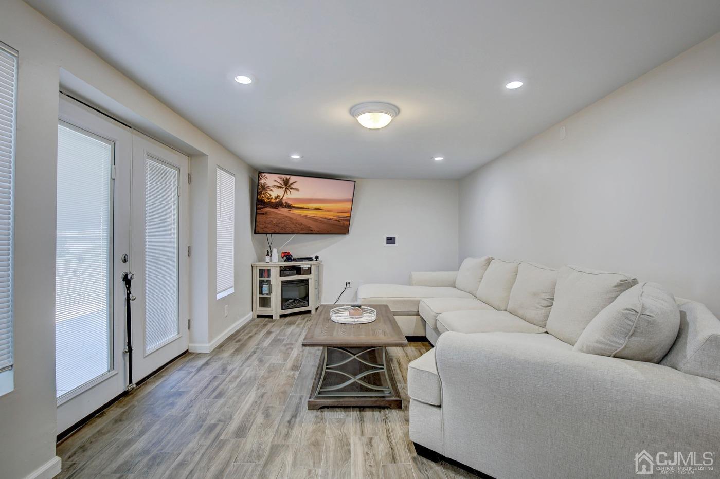 5 Thomas Street Old Bridge, NJ 08857 - Photo 16 of 36 a living room with furniture and a flat screen tv