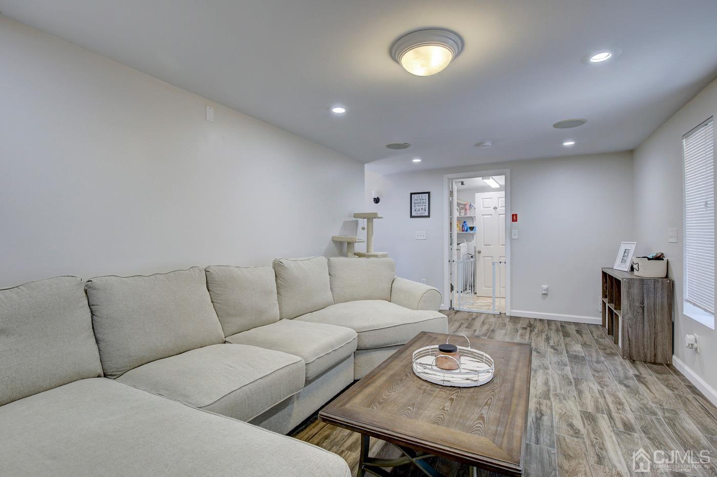 5 Thomas Street Old Bridge, NJ 08857 - Photo 17 of 36 a living room with furniture and a wooden floor