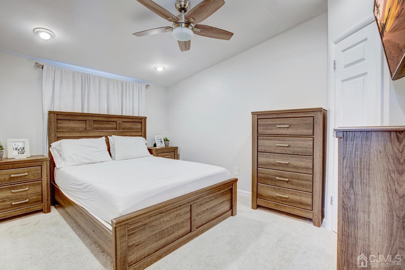 5 Thomas Street Old Bridge, NJ 08857 - Photo 21 of 36 a bedroom with a bed and a chandelier