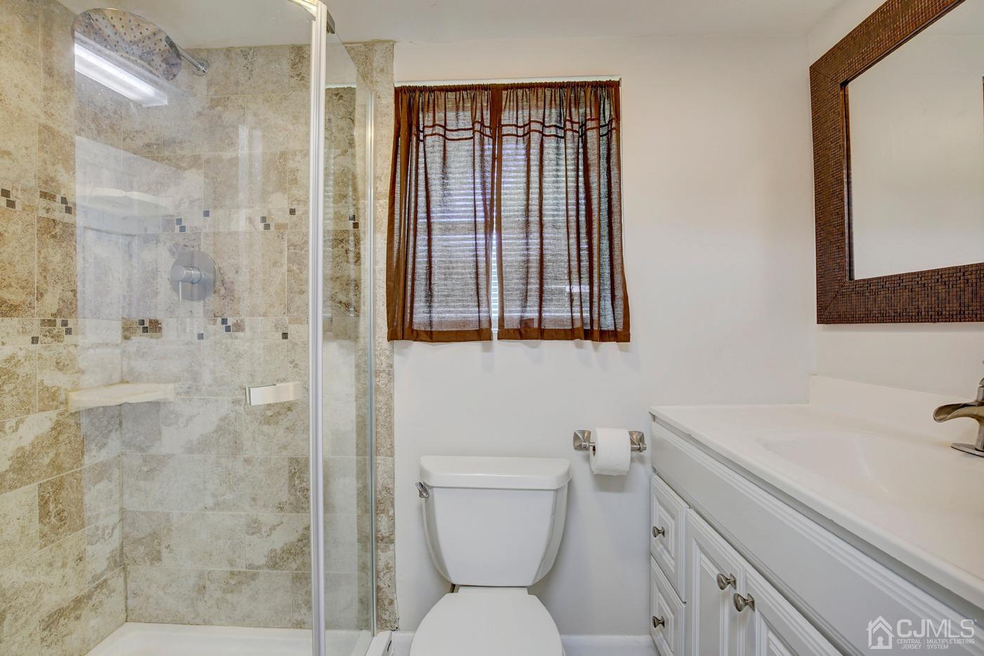 5 Thomas Street Old Bridge, NJ 08857 - Photo 22 of 36 a bathroom with a sink a toilet and shower