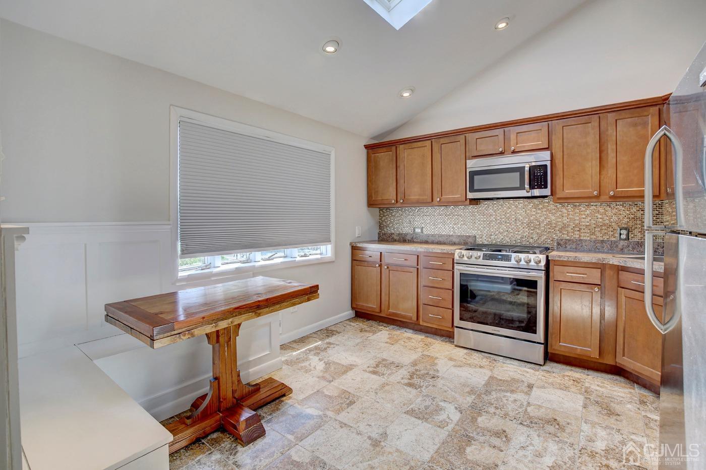 5 Thomas Street Old Bridge, NJ 08857 - Photo 9 of 36 a kitchen with stainless steel appliances a stove a sink and a refrigerator