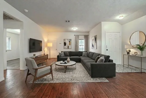 a living room with fireplace furniture and a flat screen tv