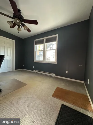 a view of an empty room and a ceiling fan