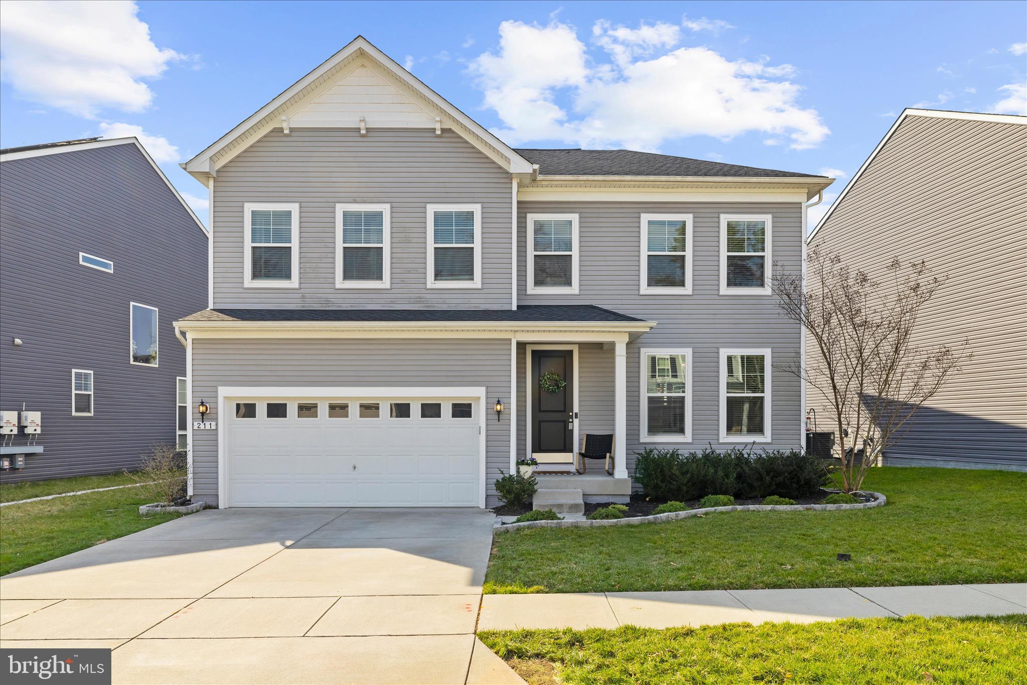 211 Harvest Blossom Road Millersville, MD 21108 - Photo 2 of 87 a front view of a house with a yard and garage