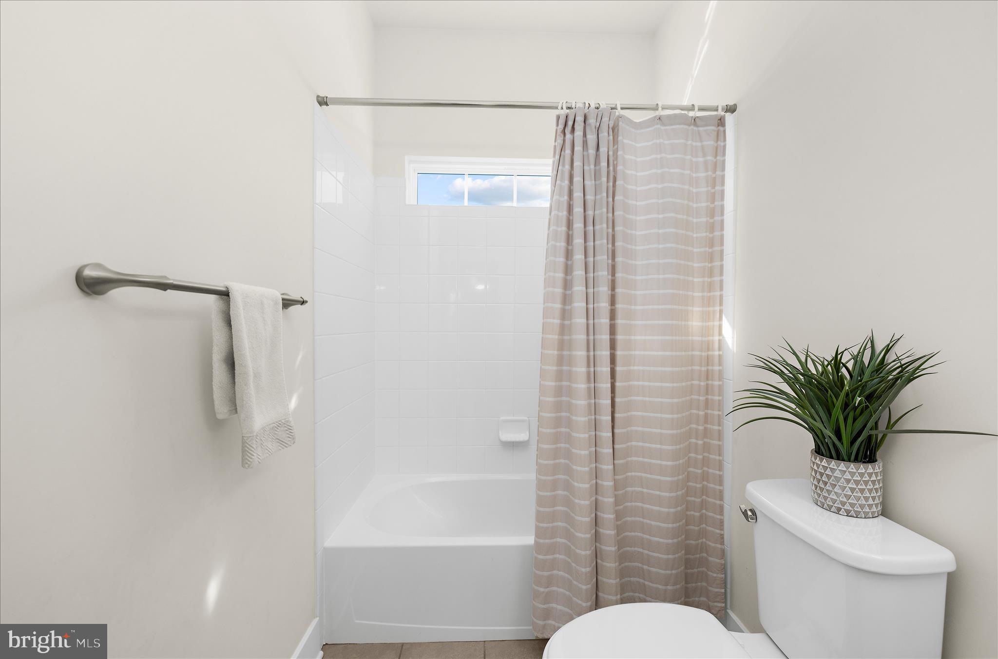 211 Harvest Blossom Road Millersville, MD 21108 - Photo 33 of 87 a bathroom with a shower curtain a mirror a toilet and sink