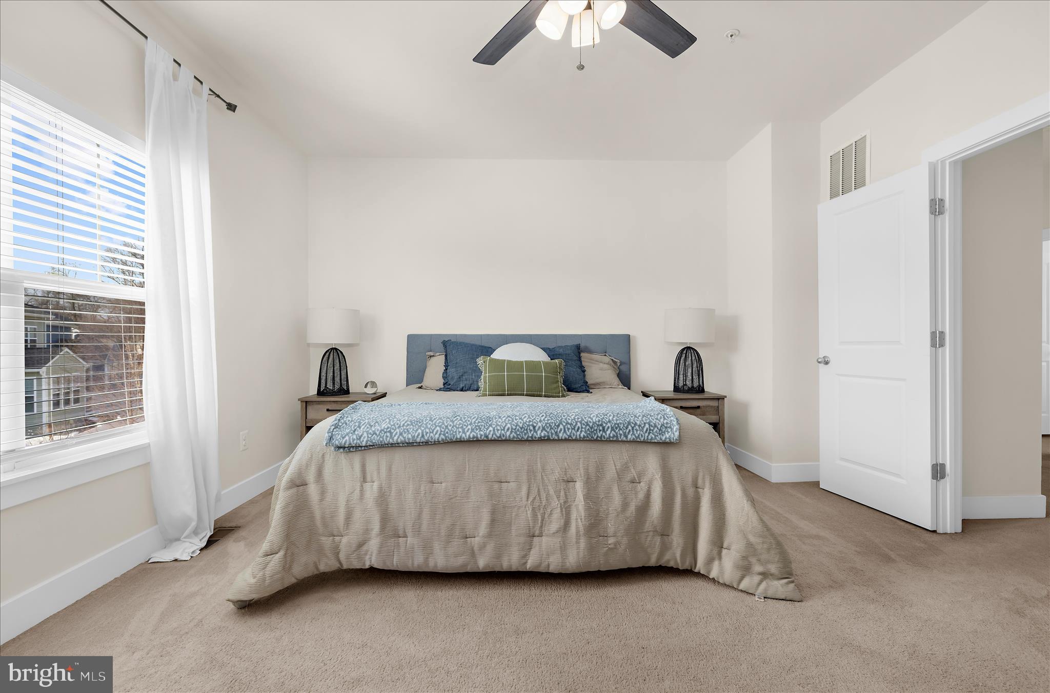 211 Harvest Blossom Road Millersville, MD 21108 - Photo 45 of 87 a bedroom with a bed and a chandelier