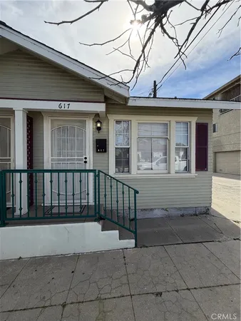 a view of a brick house with a small yard