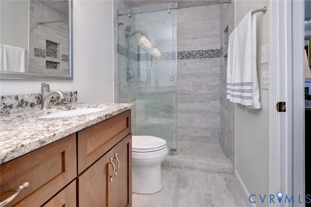 a bedroom with furniture and a floor to ceiling window