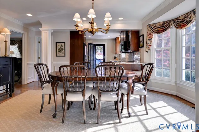 a view of a dining room with furniture and chandelier