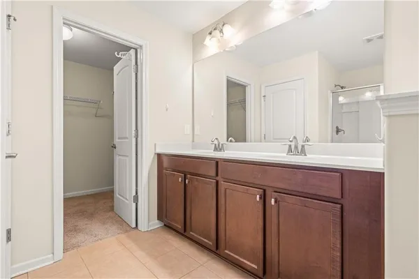 a bathroom with a double vanity sink a and mirror