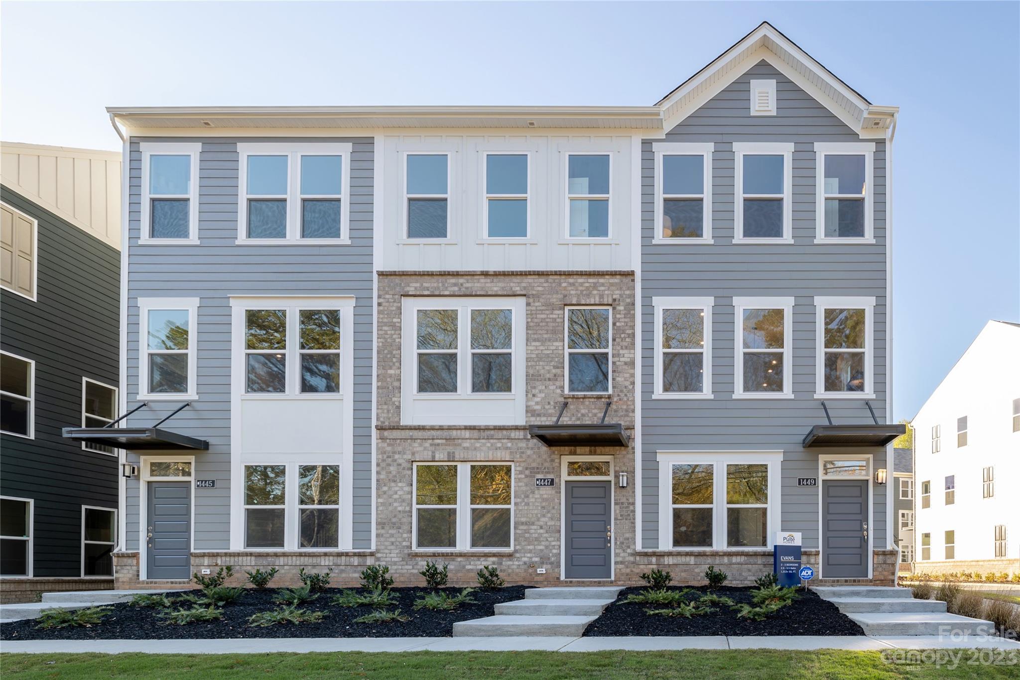 4026 Capital Ridge, Unit 5 Charlotte, NC 28205 - Photo 2 of 8 a front view of a residential apartment building with a yard