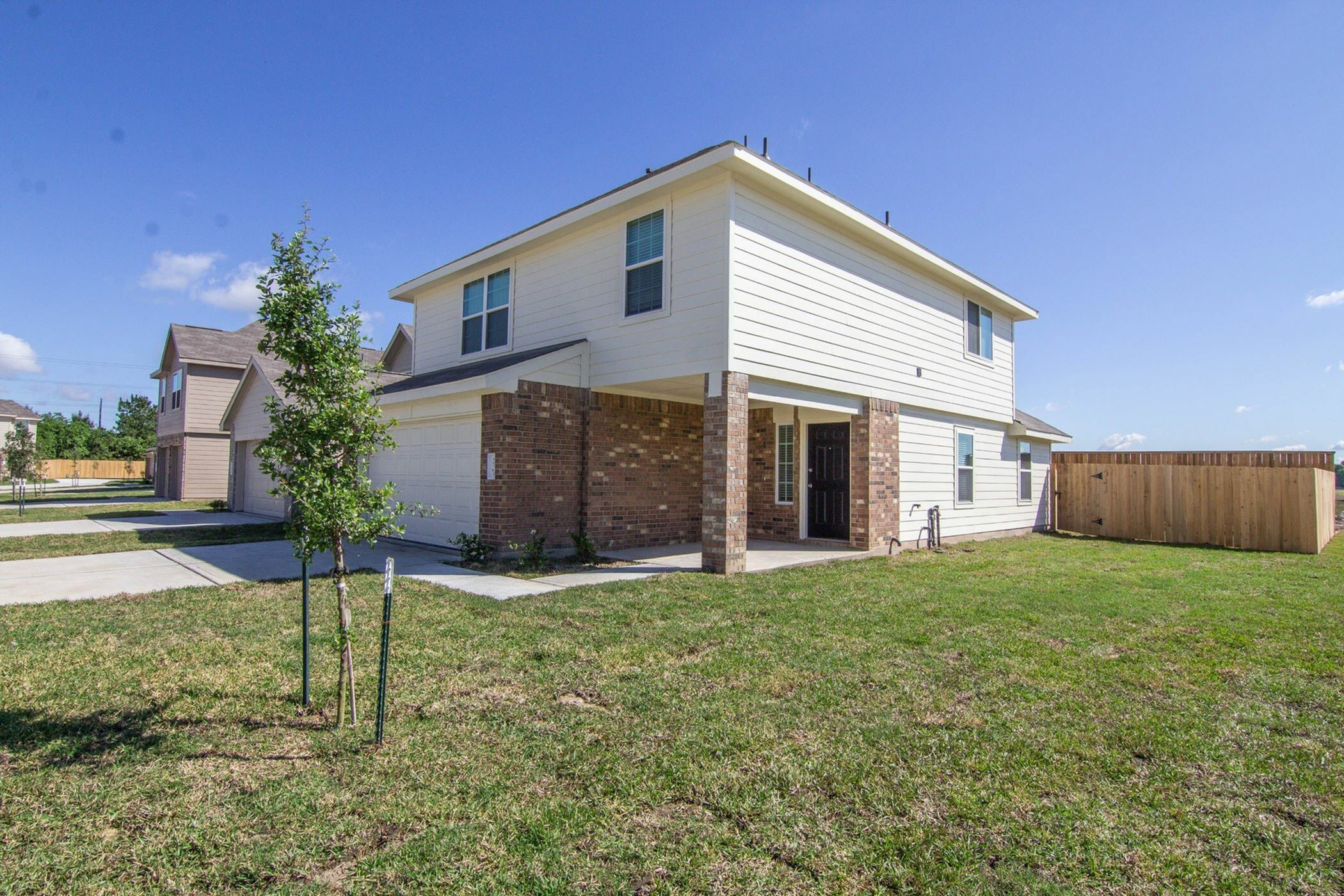 12702 Memorial Ranch Road Houston, TX 77014 - Photo 2 of 15 a front view of a house with a yard and garage