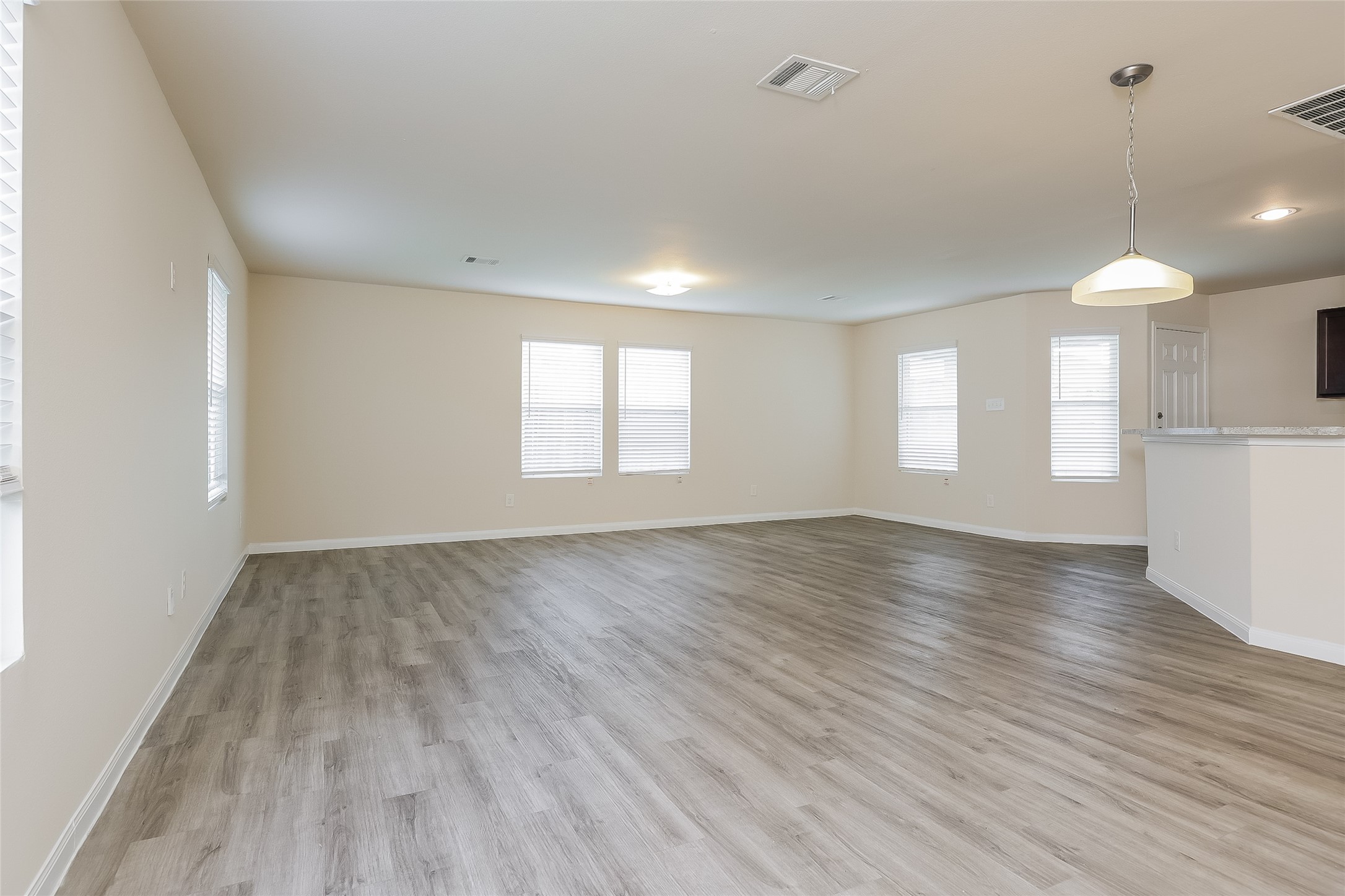 12702 Memorial Ranch Road Houston, TX 77014 - Photo 3 of 15 an empty room with wooden floor and windows