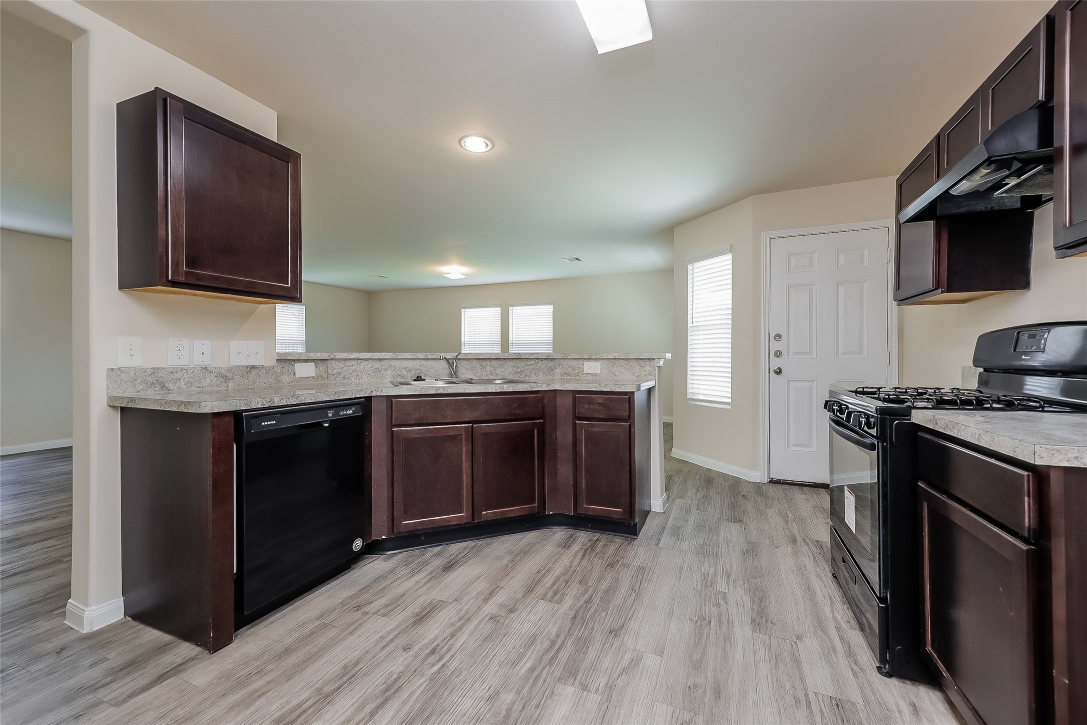 12702 Memorial Ranch Road Houston, TX 77014 - Photo 7 of 15 a kitchen with stainless steel appliances granite countertop a stove a sink and a microwave