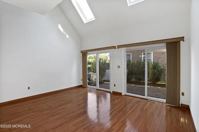 a view of a hallway with wooden floor and entryway
