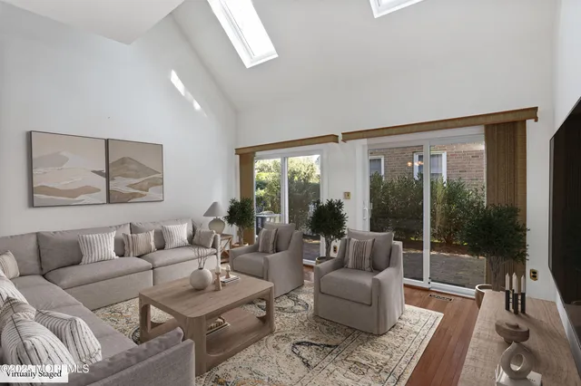 a view of a dining room with furniture wooden floor and chandelier