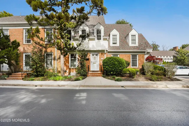 a kitchen with white cabinets sink and stainless steel appliances