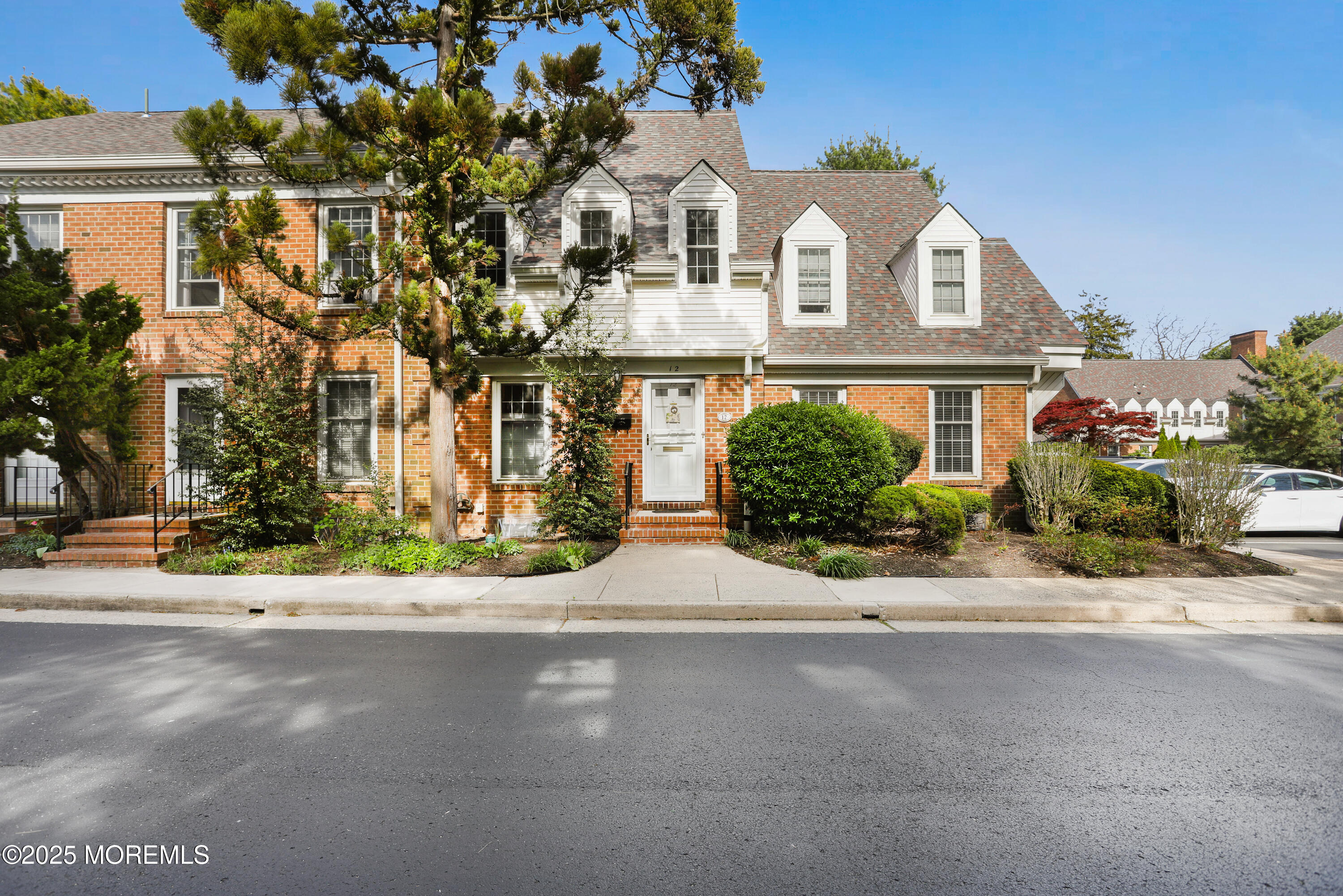 12 Wyckham Road Spring Lake Heights, NJ 07762 - Photo 2 of 39 a front view of a house with a yard and a garage
