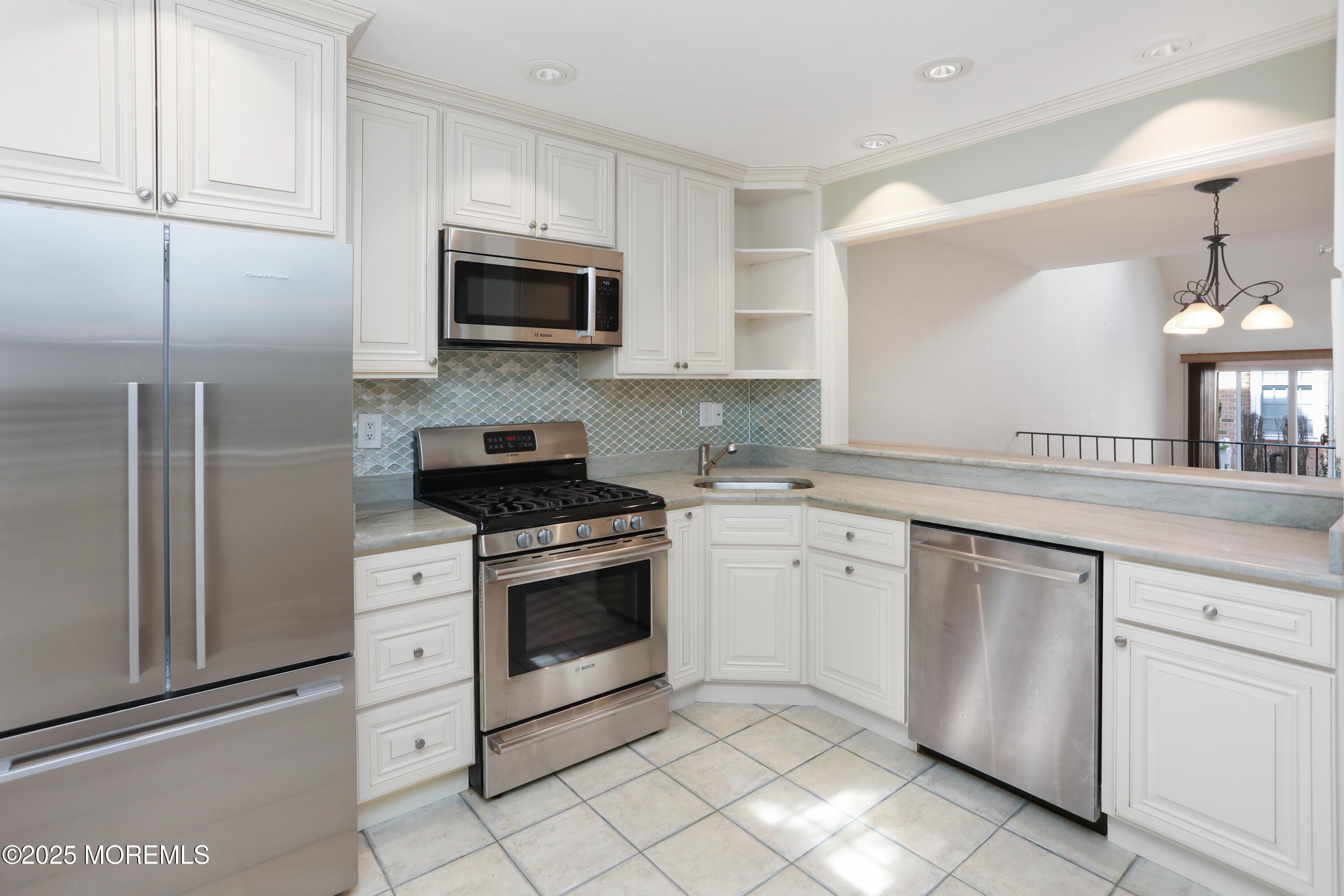 12 Wyckham Road Spring Lake Heights, NJ 07762 - Photo 3 of 39 a kitchen with white cabinets sink and stainless steel appliances