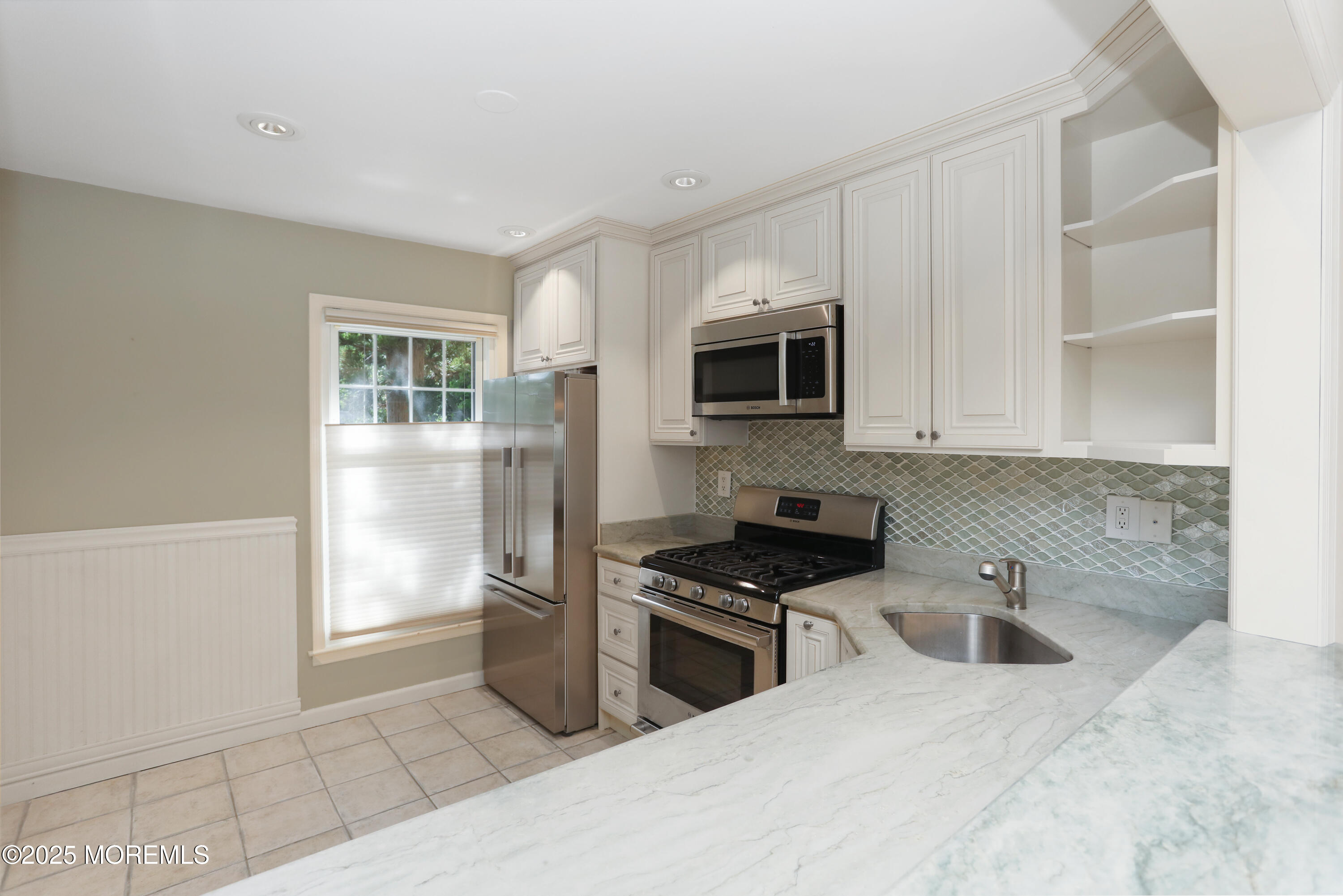 12 Wyckham Road Spring Lake Heights, NJ 07762 - Photo 4 of 39 a kitchen with stainless steel appliances a sink a stove a microwave a sink a refrigerator and cabinets