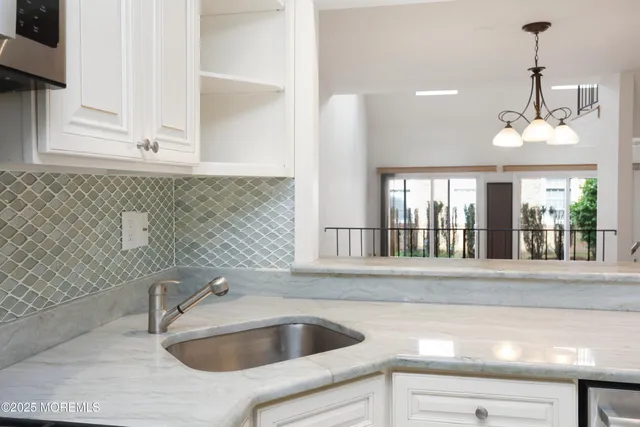 a view of a dining room with furniture wooden floor and chandelier