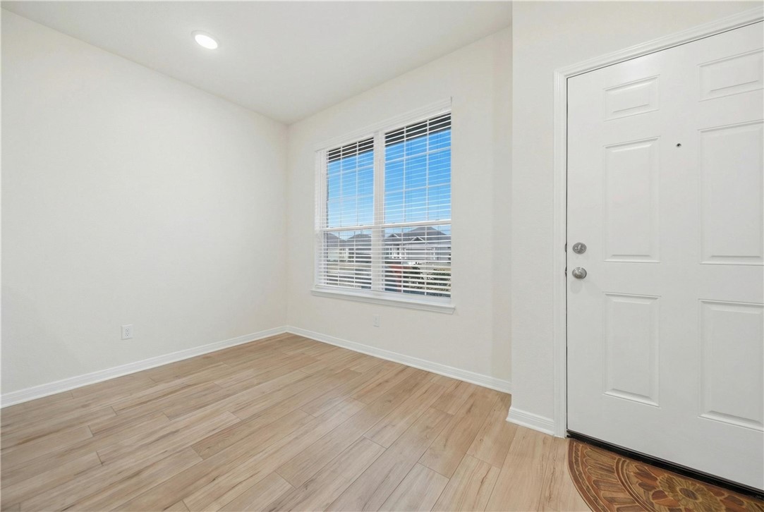 1443 Lk Rdg Drive Brenham, TX 77833 - Photo 5 of 17 an empty room with wooden floor and windows