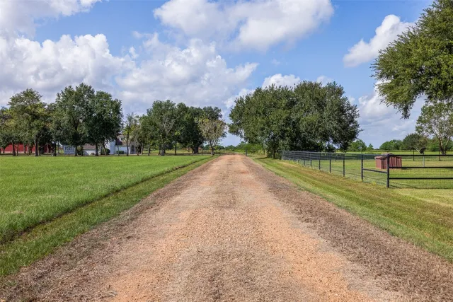 a house with huge green field in front of it