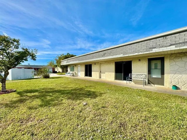 a front view of house with yard and trees