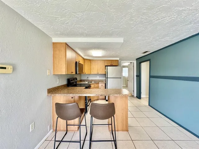 a kitchen with refrigerator cabinets and furniture