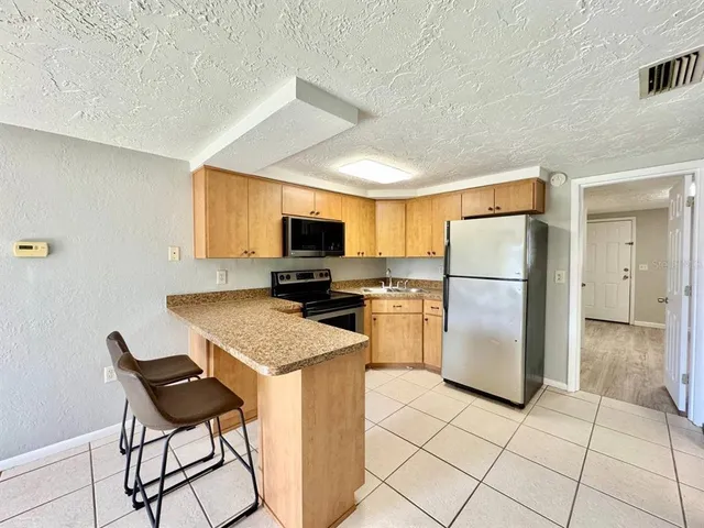 a kitchen with a stove a sink and a refrigerator