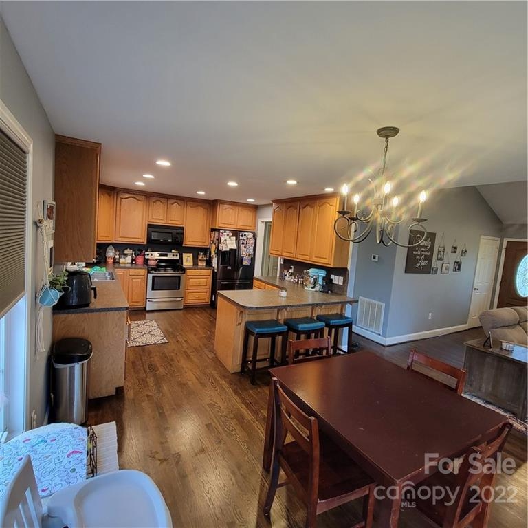 1744 Furnace Road Lincolnton, NC 28092 - Photo 3 of 15 a living room with furniture kitchen view and a chandelier